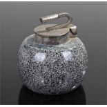 Novelty inkwell, in the form of a curling stone of speckle decorated pottery and white metal lid,