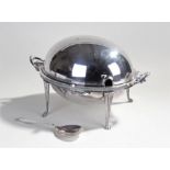 Silver plated warmer, the dome hinged top above tapering reeded legs and paw feet, 36cm wide