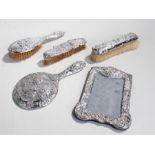 Silver objects, to include an associated vanity set and a frame, (5)