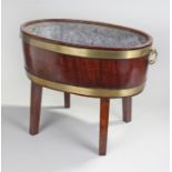 George III mahogany and brass bound oval wine cooler, with twin handles to the oval lead lined body,