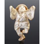 19th century Japanese ivory netsuke of a dancing actor standing on one leg and gazing upwards with
