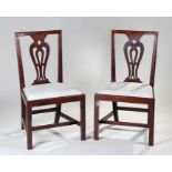 Pair of George III walnut dining chairs, the splat back above a drop in seat on square section