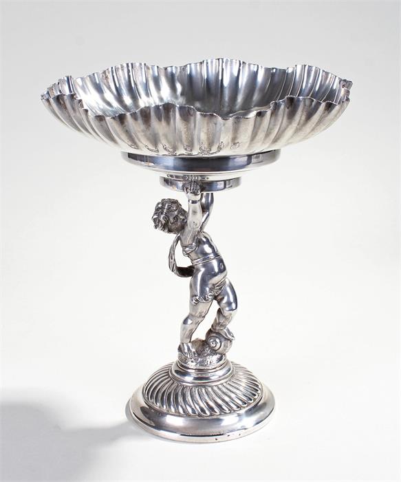 French white metal table centrepiece, the shaped bowl with gadrooned centre above a figure of a