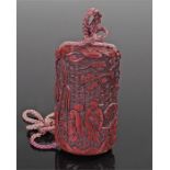 Japanese Meiji cinnabar lacquer five case inro, carved with a figural scene and trees, 9cm high