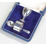 George V silver egg cup napkin ring and spoon set, London 1935, the egg cup with a ring turned edge,