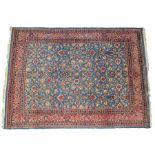 Persian carpet, with a blue ground and red flowers, the surround with a row of borders with flowers,