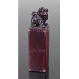 Chinese hardstone seal, surmounted by a dog of foo above a square section column, 7cm high