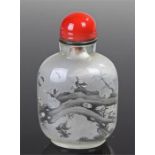 Chinese glass snuff bottle, with a red glass dome top above a decorated foliage and insect body,