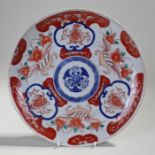 19th Century Japanese Imari plate, with a foliate blue and white medallion surrounded by flowers