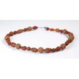 String of Chinese carved Coquillia nut and beads necklace, the beads of various designs featuring