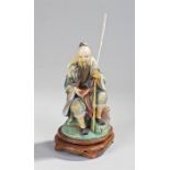 Finely carved early 20th Century Chinese ivory fisherman, the fisherman with painted decoration, a