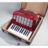 World Master accordion, in red marble effect, cased