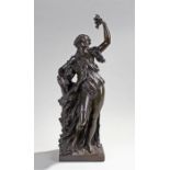 After Claude Michel Clodion (1738-1814), a large bronze figure of maiden holding grapes aloft,