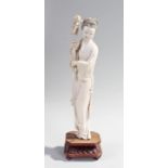 Large Chinese late 19th Century/early 20th Century ivory figure, of a lady holding aloft a flower in