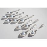 Set of ten Sterling silver dessert spoons, with scroll handles and shell capped bowls, 9.9oz, (10)