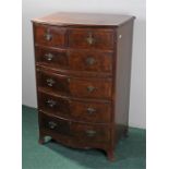 walnut bow front chest of drawers, cross banded top above a series of drawers and brushing slide