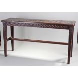 Early 20th Century oak bench, with a carved rectangular top above tapering legs