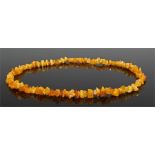 Butter scotch amber necklace, of pebble form, 65cm long, 44.4 grams