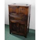 Oak drinks cabinet, the rectangular top above a drop fall, drawer to the frieze above a pair of