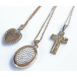 Three 9 carat gold chains and pendants, to include a cross, a heart locket and an oval locket