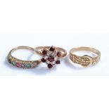 9 carat gold rings, to include a flower head example, a multi stone example and a belt type, (3)