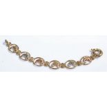 9 carat gold bracelet, with a row of dolphin links within ovals, 18.3 grams