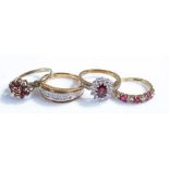 9 carat gold rings, to include two flower examples, a band and a stone set example, (4)