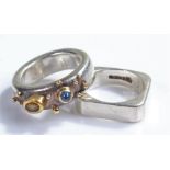 Unusual silver stone set ring, with a cabochon sapphire and brown stone set to the silver ring