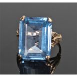 9 carat gold ring, set with an emerald cut pale blue stone, ring size Q