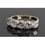 18 carat gold and diamond set ring, with a row of five round cut diamonds. The Central Largest
