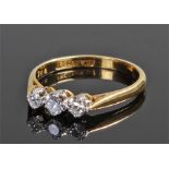 18 carat gold diamond set ring, with a trio of diamonds to the head, ring size O