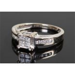 18 carat gold and diamond ring, the head with square cut diamonds and round cut to the shoulders,