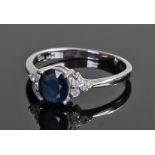 18 carat white gold sapphire and diamond ring, the central sapphire flanked by six diamonds, ring