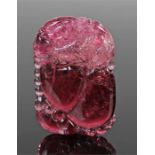 Chinese carved tourmaline pendant, carved with a beast above fruit, 47mm high