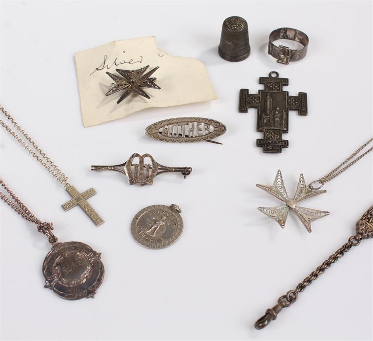 Silver jewellery, inluding a thimble, a cross, and a pendant from the Westminster Congress of