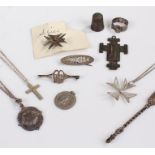Silver jewellery, inluding a thimble, a cross, and a pendant from the Westminster Congress of