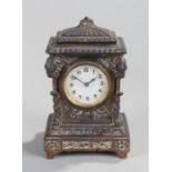 Early 20th Century mantel clock, of small proportions, the stepped top above a white enamel dial