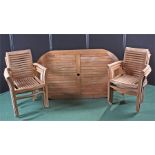 Garden table and six armchairs, the chairs with slat backs and seats