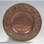 Early 20th Century copper charger, signed F Perry, with foliate and leaf decorated surround to the