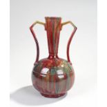 Early 20th Century flambé glazed twin handled vase, the tapering neck with angled handles above a