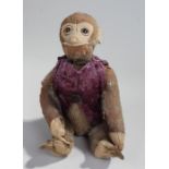 Schuco yes/no monkey stuffed toy, the head with glass eyes above a purple waistcoat, moveable head