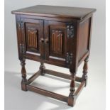 17th Century style oak bedside cupboard, with a rectangular top above a pair of linen fold doors and
