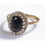 9 carat gold sapphire set ring, the central oval sapphire with stone surround, ring size L