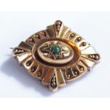 Victorian yellow metal mourning brooch, with central green stone, glazed case back, 37mm wide