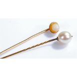 Two pearl stick pins, on yellow metal pins, cased within a S.Mitani Yokohama box, (3)