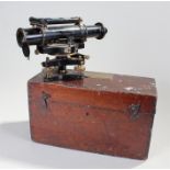 Cased theodolite, the black lacquered body with brass fittings