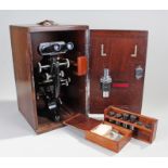 Watson of London microscope, with a black and steel body, additional lenses, housed within the