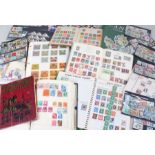 Assortment of loose stamps, a partially-used Stanley Gibbons Canada album, two empty stock books,
