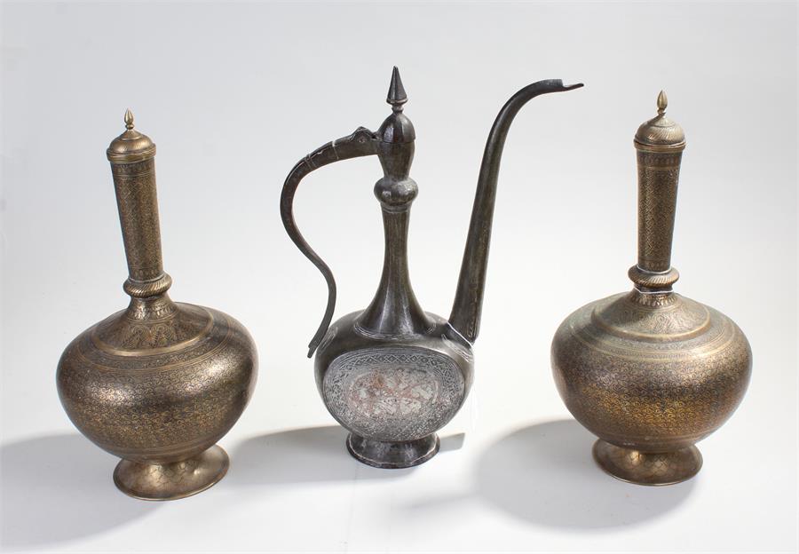 Pair of early 20th Century brass Middle Eastern vases and covers, decorated with rows of sea