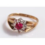 9 carat gold ring, with a flower head, red stone to the centre, 2.8 grams